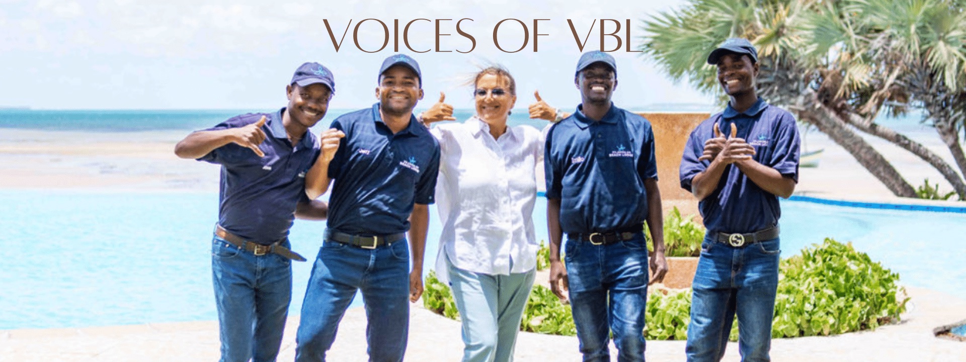 Angela Caratelli with four members of the Vilanculos Beach Lodge team beside the pool overlooking the Indian Ocean